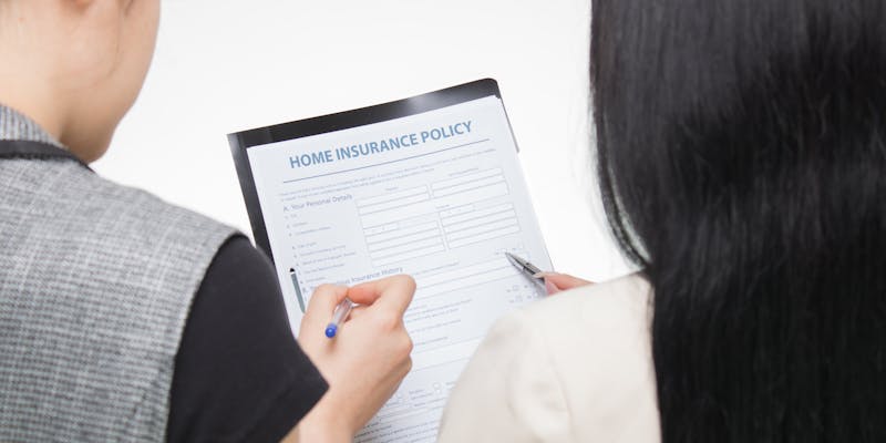 Public adjuster reviewing insurance claim fee documents with client