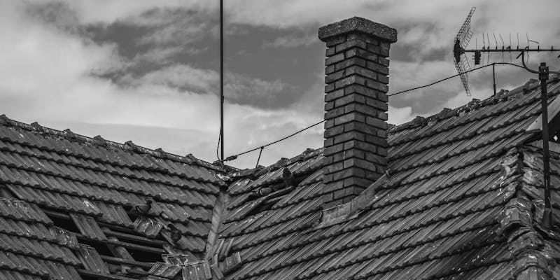 Hail-damaged asphalt shingle roof showing granule loss and impact marks on Louisiana home